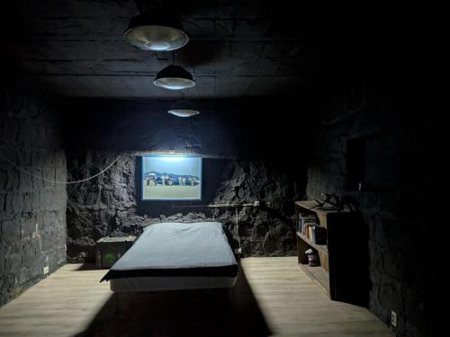 a dark room with a bed in a stone wall at K7- Bunker in Kapan
