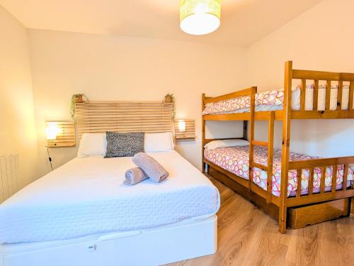 a bedroom with a bed and a bunk bed at Apartamento Casa Blanca in Tramacastilla de Tena