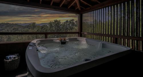a bath tub in a room with a view at Poppy’s Place Cabin in Dandridge