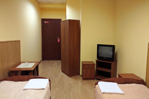a hospital room with two beds and a tv at Art Hotel Palma in Lviv