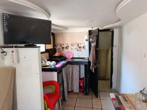a kitchen with a desk and a television in a room at tbs1 in Safi