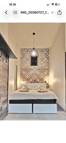 a bedroom with a large bed with a wall at SenoRita2 Magánszállás in Miskolc