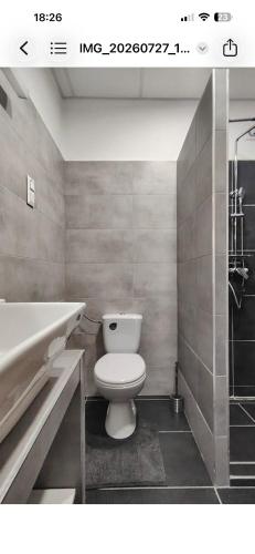 a bathroom with a toilet and a sink and a tub at SenoRita2 Magánszállás in Miskolc