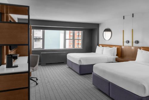 a hotel room with two beds and a desk at ARC Hotel, Washington DC, Series by Marriott in Washington, D.C.