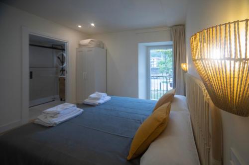 a bedroom with two beds and a large window at Un buen día in Ramales de la Victoria