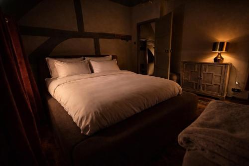 a bedroom with a large white bed and a dresser at Luxury Countryside Escape in Ipsden