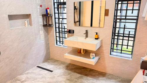 a bathroom with a sink and a mirror at EZER HOMEs in Kampala