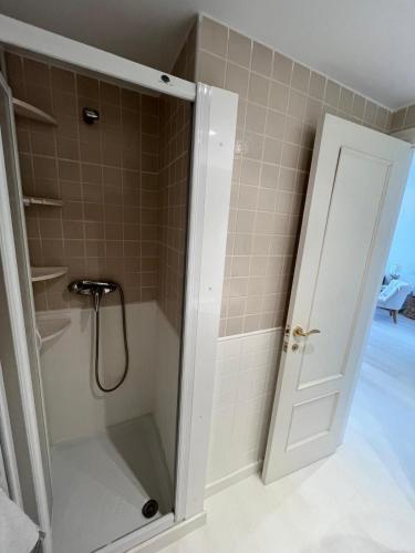 a shower with a glass door in a bathroom at Condo with golf course views, pool and terraces in San Jorge