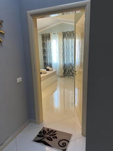 a hallway with a mirror and a rug on the floor at Treeolives in Shkodër