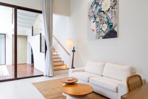 a living room with a white couch and a table at Qabalah Villa Private Pool & Rooftop Garden Stylish 2BR Retreat near Bang Tao in Ban Pak Lak