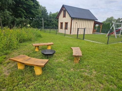 three picnic tables and a grill in a field at Przystanek Semlin - Za Jeziorem in Semlin