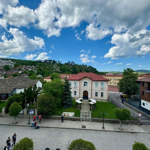 a group of people walking in front of a building at Tryavna Central Apartments-Harmony in Tryavna