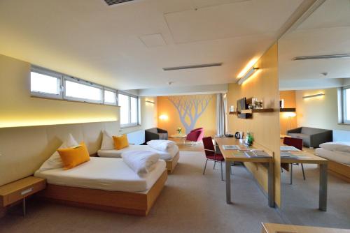 a hotel room with two beds and a desk at Antonie Hotel****superior in Frýdlant