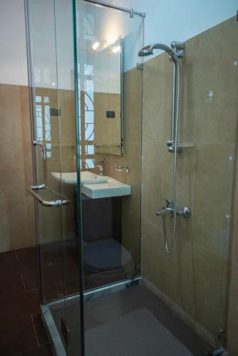 a bathroom with a shower and a sink at Eco Serenity Kandy in Kandy