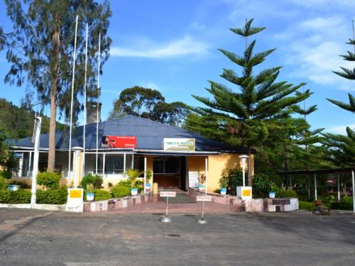 a building with a christmas tree in front of it at Mbeya Hotel in Mbeya
