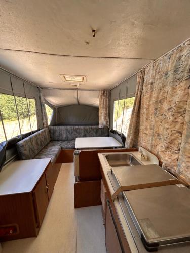 an interior of an rv with a kitchen and a sink at Privet creek side glamping in Chase