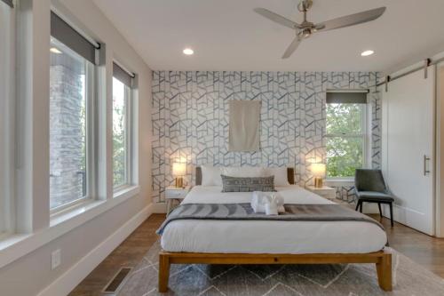 a bedroom with a large bed and two windows at Spacious Gulch Retreat Super Skyline Views in Nashville
