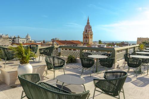 a patio with tables and chairs on a roof at Hotel El Balconario by Faranda Boutique in Cartagena de Indias