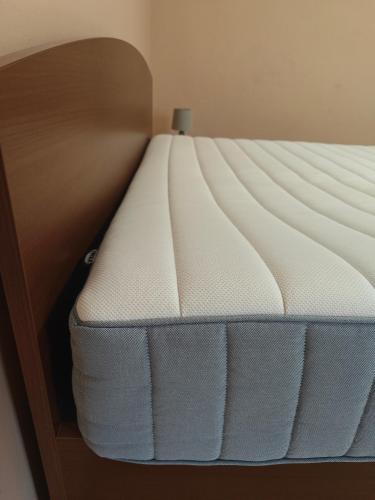 a close up of a bed with a white mattress at Villa Ladver in Hévíz