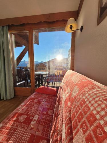 a bedroom with a bed and a large glass window at Sunny chalettt great view ski in Puy-Saint-Vincent
