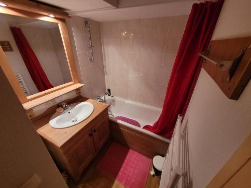 a small bathroom with a sink and a bath tub at Sunny chalettt great view ski in Puy-Saint-Vincent
