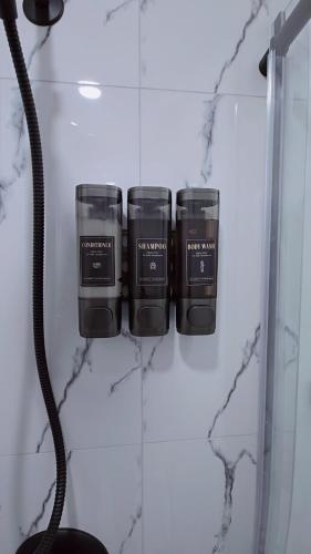 three candles sitting on a counter in a bathroom at Suite in Ambleton - Calgary in YYC