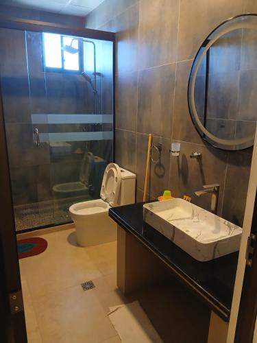 a bathroom with a sink and a toilet and a mirror at Hotel Cristales De Sal in Uyuni