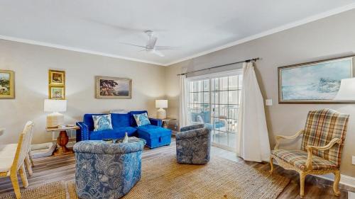 a living room with a blue couch and chairs at Rehoboth Crossing - 36983 Grindstone Ln in Rehoboth Beach