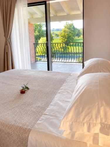 a bedroom with a bed with a view of a balcony at Incanto del Garda in Monzambano