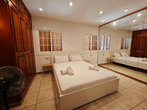 a bedroom with a bed with a fan and a mirror at Bonamar in Cabrera de Mar