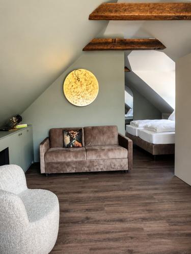 a living room with a couch and a bed at Büdel's Spessart Lounge in Lohr am Main