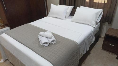 a bedroom with a bed with two towels on it at Suite Pipa Beleza Spa Resort in Pipa