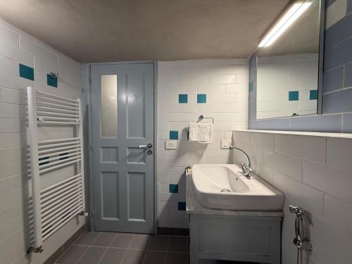 a white bathroom with a sink and a mirror at Dar el Maasser in Maasser El Chouf