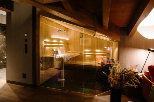 a room with a glass door with a bed in it at Bergwelt Grindelwald - Alpine Design Resort in Grindelwald