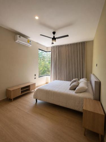a bedroom with a large bed and a window at Villa horizonte in Playa del Carmen