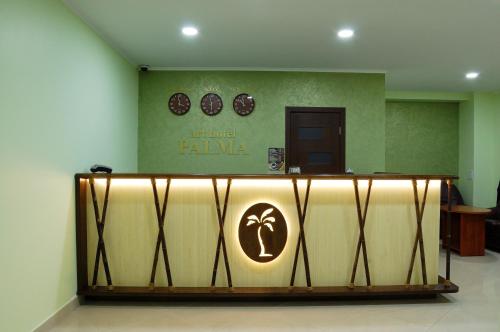 a lobby with a table with a sign on it at Art Hotel Palma in Lviv