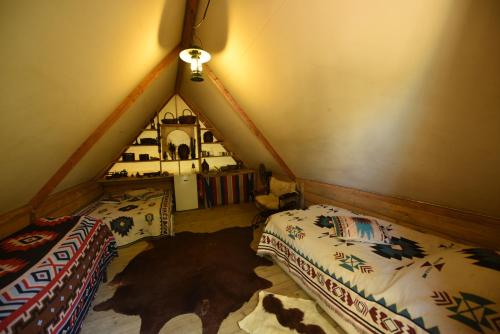 a room with two beds and a room with a tent at Logement insolite glamping tipi et lodge Var Grimaud in Grimaud