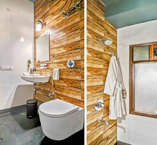 a bathroom with wooden walls and a toilet and a sink at Hotel Church House - Rohini I Near Metro I Spacious Rooms I Friendly Staff I Most Preferred Hotel In Rohini in Delhi