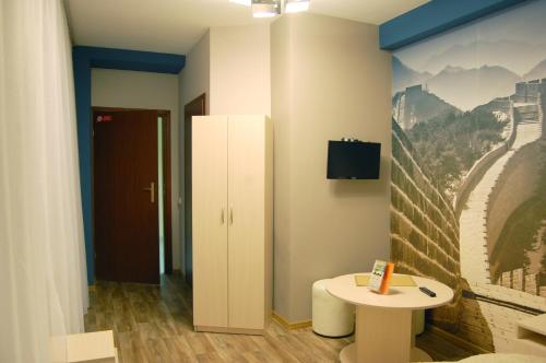 a room with a table and a wall with a picture at Art Hotel Palma in Lviv