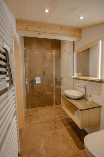 ein Badezimmer mit Dusche und Waschbecken in der Unterkunft Pension Gerstenbrand in Fischbachau