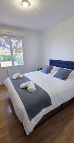 a bedroom with a large bed with two towels on it at Maison Mirepoix 100m2 in Mirepoix