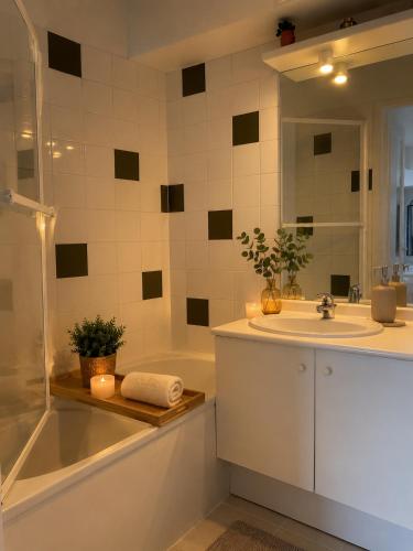 a bathroom with a tub and a sink and a shower at SUNSET 3o2 in Cayeux-sur-Mer