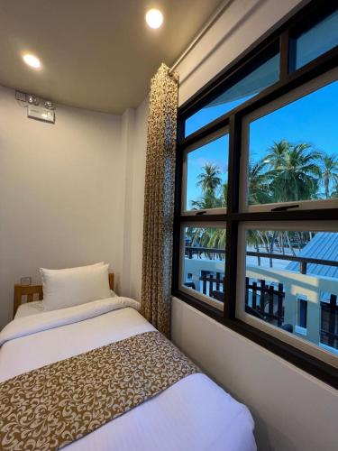 a bedroom with a window with a view of the ocean at Sunview Residence in Kaashidhoo
