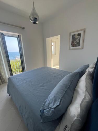 a bedroom with a bed with a view of the ocean at Marefuori Suite in Minori