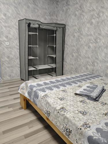 a bed in a room with a shelf at Vardan's Guest House in Yerevan