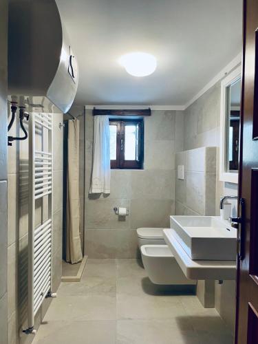 a bathroom with a sink and a toilet at Agriturismo Zizzi in Ceglie Messapica