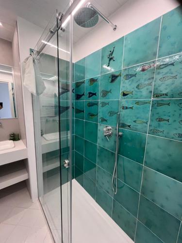a bathroom with a shower with a glass wall at Marefuori Suite in Minori