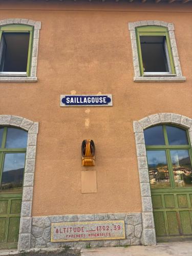 a building with a sign on the side of it at L'auberge de la Ludogare in Saillagouse