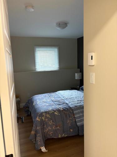 a bedroom with a bed and a window at Happy Homes in St. John's