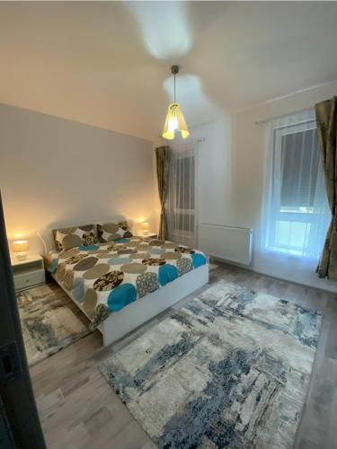 a bedroom with a bed and a rug at Tomorrowland Residence in Boom